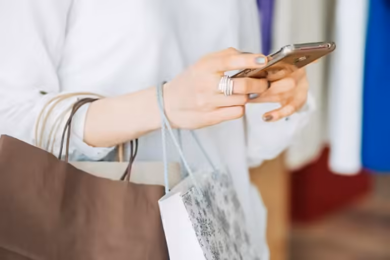 Woman with phone making an online purchase